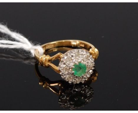 An 18ct gold emerald and diamond cluster ring, the centre round cut emerald weighing approx 0.22ct, 4.2g, size: note sized do