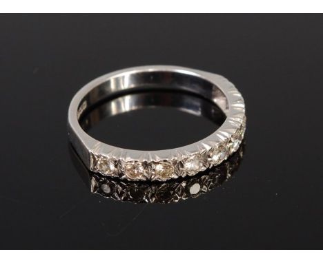 An 18ct white gold diamond half eternity ring, as nine small brilliants, total diamond weight estimated at 0.54ct    Conditio