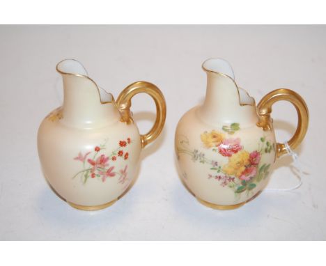 A pair of circa 1900 Royal Worcester blush ivory jugs, each decorated with floral sprays, puce mark verso, shape No.1094, h.1