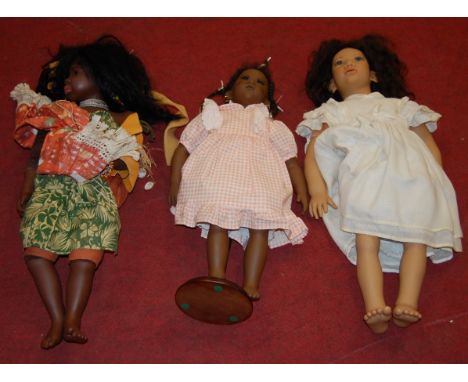 A Karim Schmitz model doll, together with two other similar boxed examples (3)