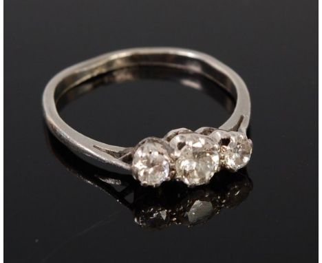 A platinum diamond three stone ring, the centre claw set brilliant weighing approx 0.2ct, 2.4g, size I 