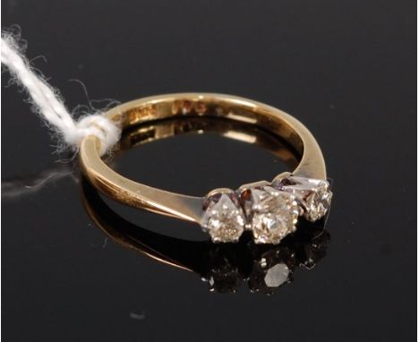 An 18ct gold diamond three stone ring, the centre brilliant weighing approx. 0.2ct, 2.2g, size I