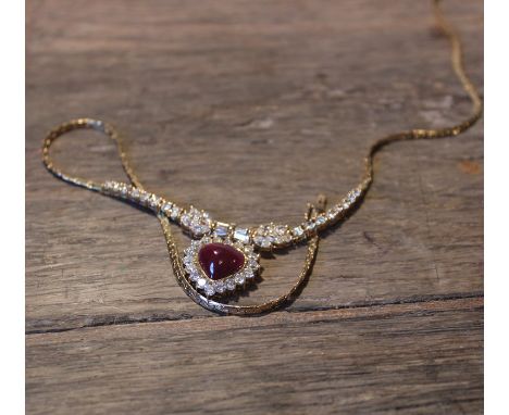 An 18ct. yellow gold, cabochon ruby and diamond set pendant necklace,&nbsp;having heart shape pendant mount set heart shape c