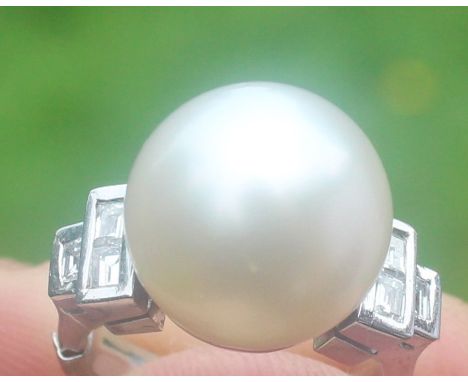 A white metal, South Sea pearl and diamond ring, set large cultured South Sea pearl to centre with three rectangular table cu