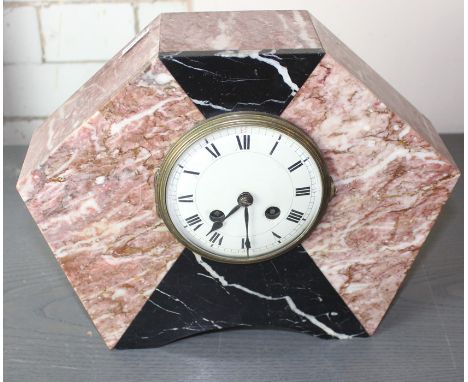 An Art Deco variegted pink marble and black onyx mantle clock, of hexagonal form, having white enamel Roman numeral chapter r