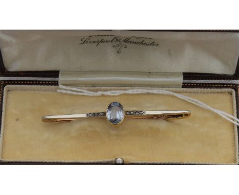 A 15ct. gold, light blue stone and diamond bar brooch, bezel set oval cut light blue stone to centre with graduated rows of r