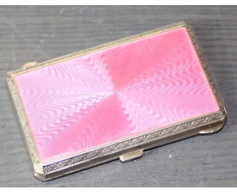A pink enamelled silver rectangular cigarette case, imported by F B Reynolds, assayed London 1911, having sunburst pink guill