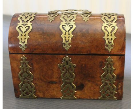 A 19th cent domed walnut tea caddy with brass Gothic revival strapwork
