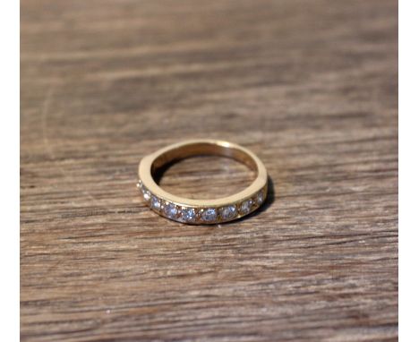 An 18ct. gold half hoop diamond ring, set ten round brilliant cut stones, (total diamond weight approx. 0.50 carats), stamped