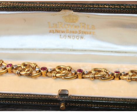 An early 20th century French 18ct. yellow gold bracelet set rubies and diamonds, fashioned from navette form wire work links,