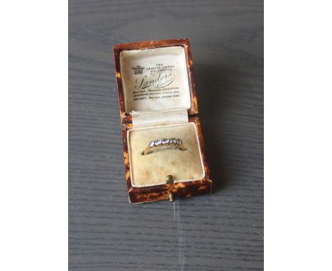 An 18ct. gold five stone diamond ring, shank stamped "18ct Plat". (gross weight 1.6g), in box.