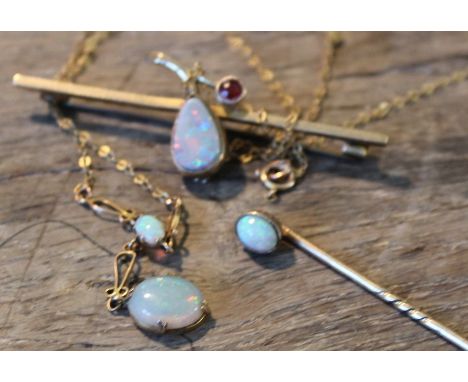 A collection of 9ct. gold and opal set jewellery, to include; a 9ct. gold, opal and red stoine bar brooch, set tear drop cabo