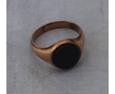 A yellow metal signet ring,&nbsp;set oval sard, (yellow metal assessed as 14ct. rose gold). (gross weight 5.9g)