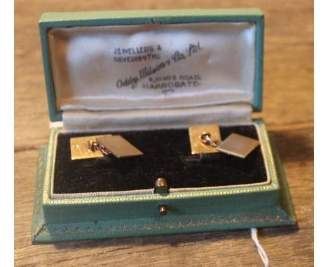 A pair of 9ct. yellow gold rectangular engine turned cuff links, chain link fitting, assayed London 1951, (7g), in fitted ret