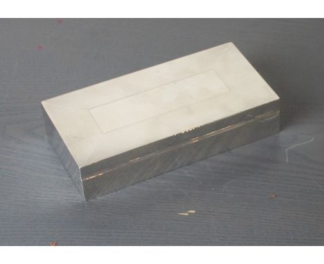 A silver rectangular cigarette box, by Padgett & Braham Ltd, assayed London 1956, with engine turned decoration to lid and di