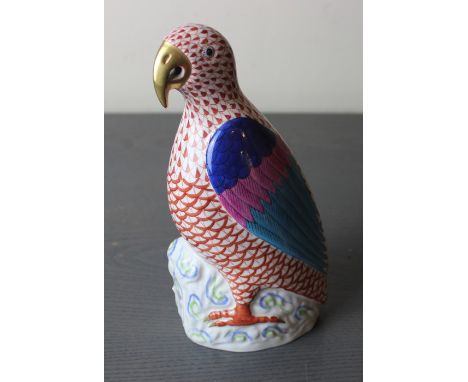 A Herend hand painted porcelain parrot, modern, decorated in fishnet rust red and gilt heightened, model 5007, height 21.1cm.