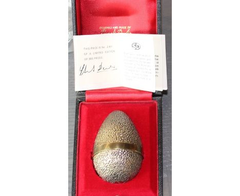 A cased limited edition Stuart Devlin "surprise" silver gilt Easter egg, assayed London 1969, the textured shell opening to r