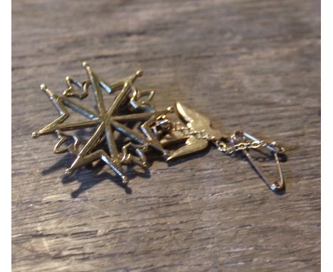 A 9ct. gold eight point star and swallow brooch,&nbsp;fashioned as a stylised compass suspending swallow in flight, assayed L