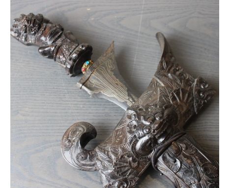 A Balinese dagger Kris,&nbsp;early 20th century, of traditional form, with straight parnor blade (length 33.5cm), wooden hilt