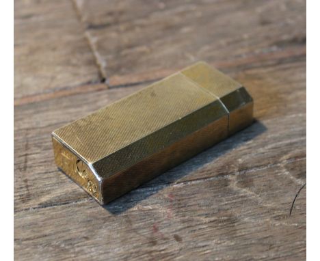 A Must de Cartier engine turned gold plated gas lighter.