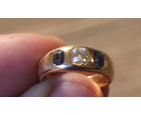 An 18ct. yellow gold, diamond and sapphire ring, set old round cut diamond to centre flanked by single mixed cut sapphire to 