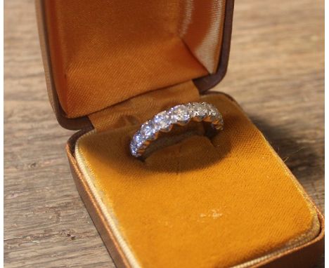 An 18ct. white gold and nine stone diamond ring, set row of nine round brilliant cut diamonds (the largest to centre approx. 