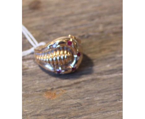 An 18ct. gold and ruby set stylised buckle ring, set five round eight cut rubies, shank stamped "750". (gross weight 7.9g)