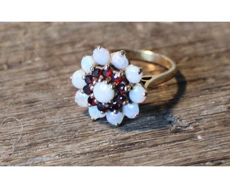 A 9ct. gold, opal and garnet cluster ring, shank hallmarked London 1971. (gross weight 4.5g)