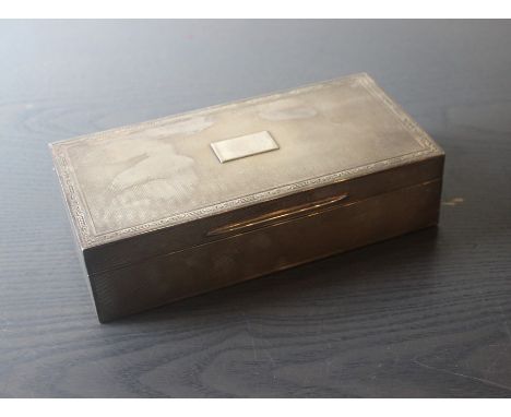 A silver rectangular cigarette box, by Mappin & Webb Ltd, assayed London 1928, with engine turned decoration and rectangular 