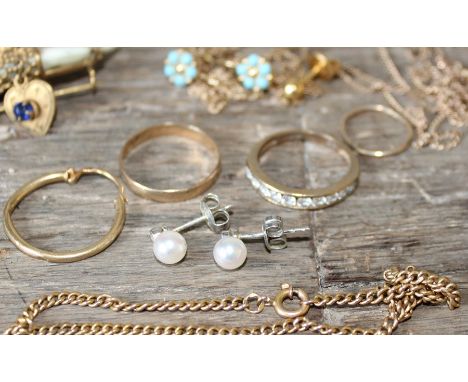 A collection of yellow metal jewellery, to include; a hallmarked 9ct. gold band, a hallmarked 9ct. gold and clear stone half 