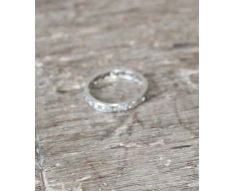 A white metal and diamond eternity ring,&nbsp;set twenty-four eight cut diamonds, one stone missing, (each approx..0.02-0.03 