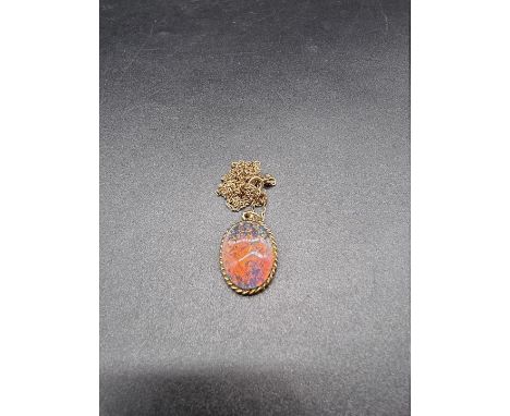 A 9ct gold and opal pendant, 22mm high, on a 9ct gold chain, gross weight 7.2g. 