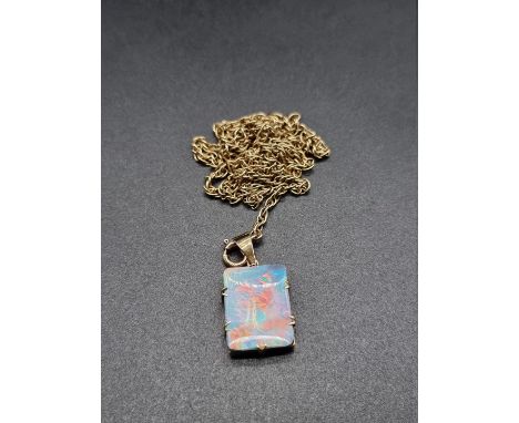 A yellow metal and opal pendant,&nbsp;18mm high, on a yellow metal chain stamped '375' to clasp, 65cm. 