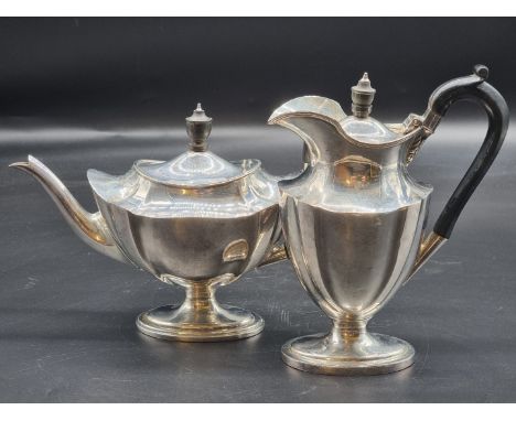 An Edwardian silver teapot and matching hot water jug, by Thomas Bradbury &amp; Sons, London 1905/6, 865g all in, latter 19cm