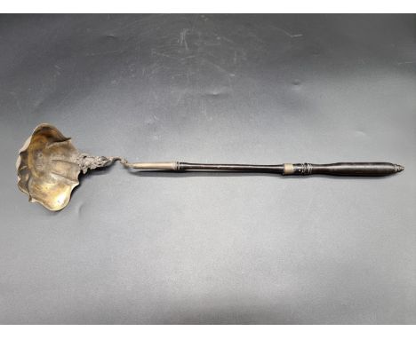 A 19th century Danish silver gilt ladle, marks rubbed, with ebony handle, 44cm long. 