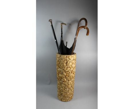 A Cylindrical Stick Stand Containing Edwardian Gilt Handled Parasol, Two Silver Mounted Walking Sticks, Swagger Stick and Umb