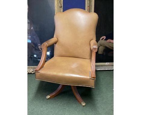 Large winged back light tan and studded brass leather arm chair, on 4 legs to castors 