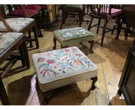 A beech stained upholstered footstool with handworked floral tapestry panel, with velvet border, on carved moulded supports, 