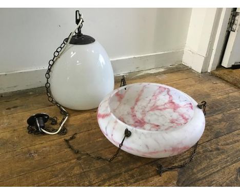 An opaque snowdrop style glass pendant light fitting with bronzed metal fixing and a 1930s pink marbled opaque glass ceiling 