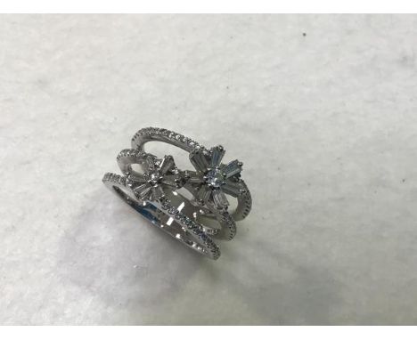 An 18ct white gold diamond floral cluster triple band ring, complete with original purchase document etc. (total weight 0.97c