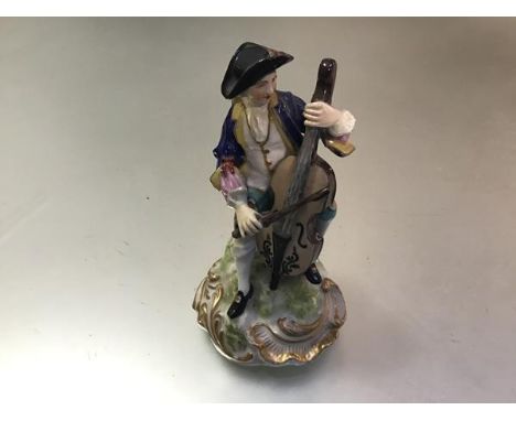 A Samson Derby 19thc porcelain figure of a Seated Cellist, raised on gilt socolo base, decorated with polychrome enamels, Sam