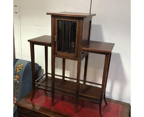 An Edwardian mahogany miniature display stand, the square top above a glazed panel door, enclosing a plain fitted interior, f