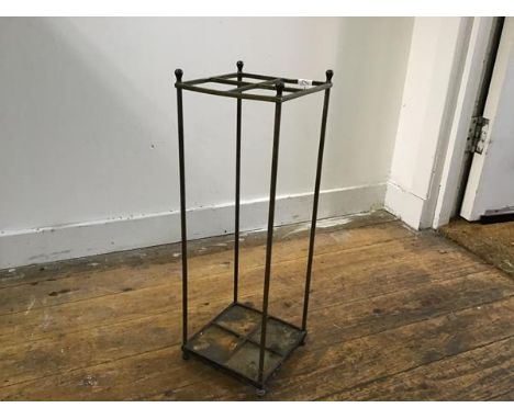 An Edwardian cast brass four section upright open stick stand, on cast iron base (h.54cm x 18cm x 18cm)