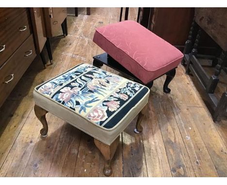 A walnut upholstered footstool with tapestry top, raised on carved moulded supports and pad feet and a stained adjustable foo
