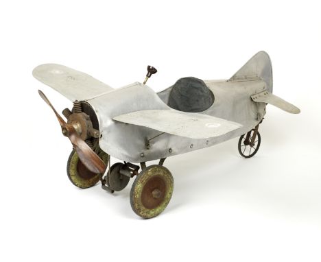 A single-seat childs's pedal monoplane, British, 1930s,pressed alloy bare metal riveted body, crank pedals driving simple ste