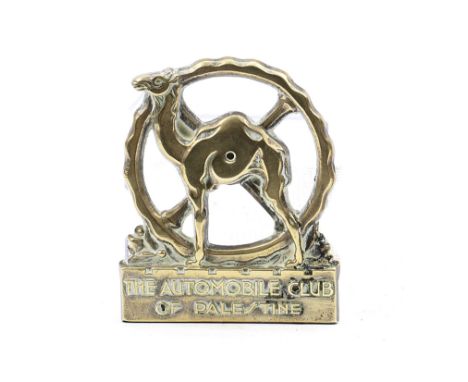 An 'Automobile Club of Palestine' member's badge, 1930s,cast brass with design in relief of a camel and a steering wheel, 11.