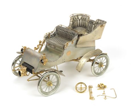 A 1:8 scale silver and gold model of a 1903 Model A Ford, by American Silversmiths Guild and Cartier for Ford Diamond Anniver