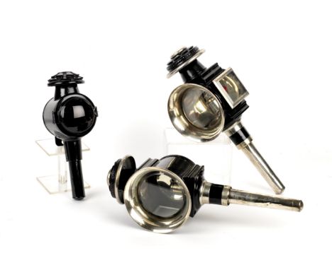 A set of three candle coach lamps,comprising two front and one rear, black painted bodies, the front pair with nickelled rims
