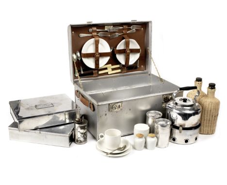 A 'Sirram' metal cased picnic set for four persons,pressed steel outer case with leather handles, the lid opening to interior