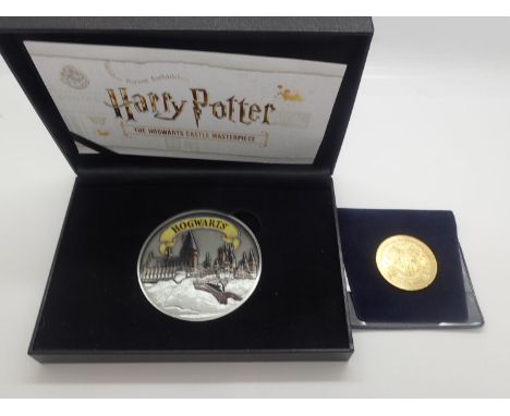 A cased large Harry Potter coin with a Westminster Harry Potter coin. UK P&amp;P Group 1 (£16+VAT for the first lot and £2+VA